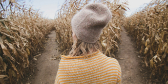 Image of a woman choosing between two paths in a field